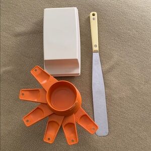 Lot: Ekco Flint 12" frosting spatula, Tupperware butter dish, & measuring cups